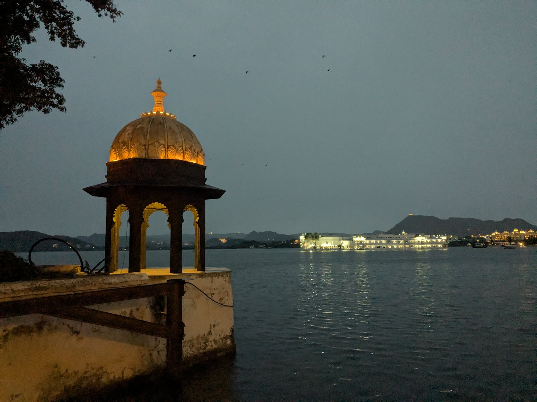 Lake Pichola and illuminated palaces at night in Udaipur