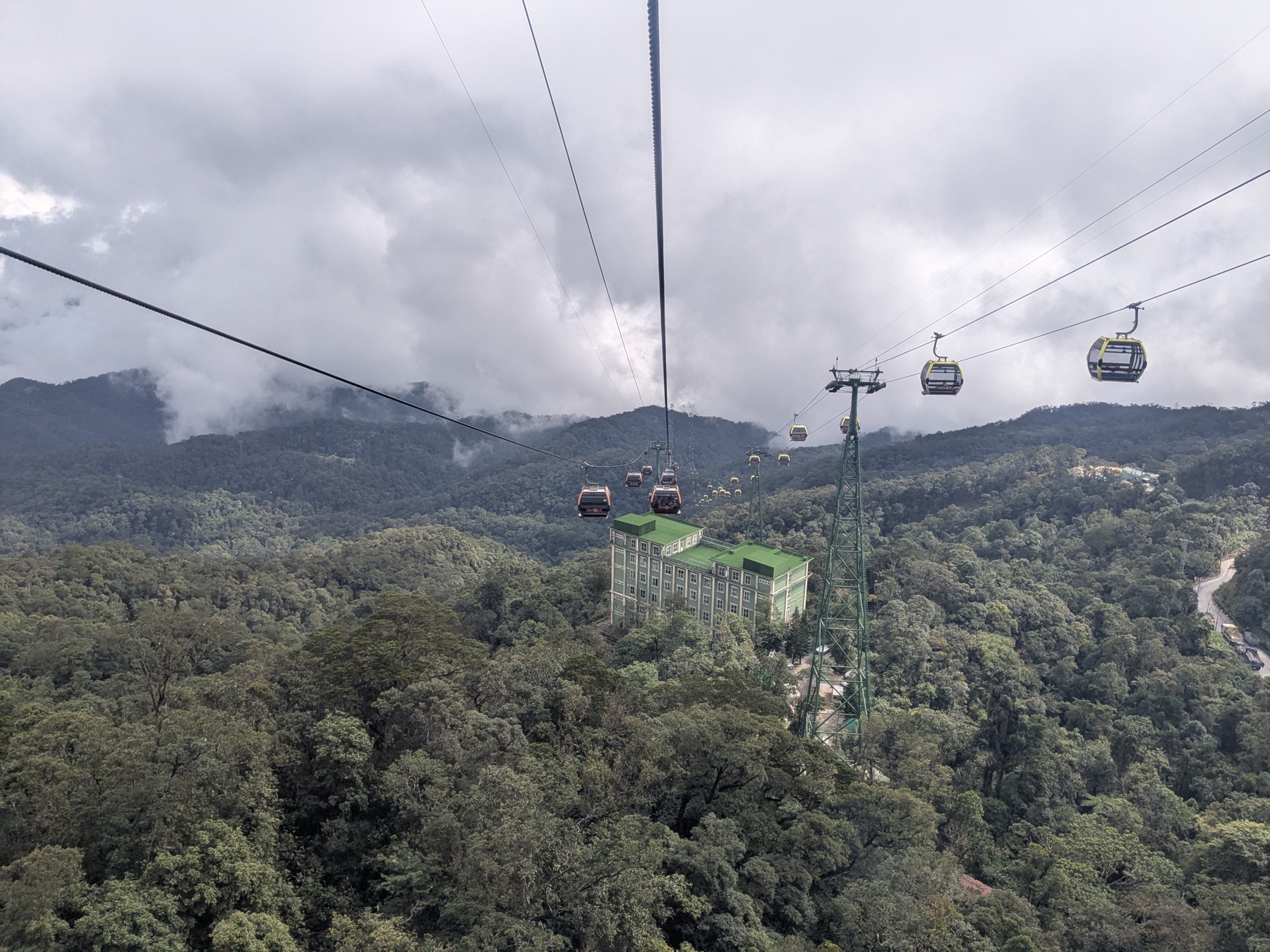 Cable cars crossing a forested valley at Ba Na Hills