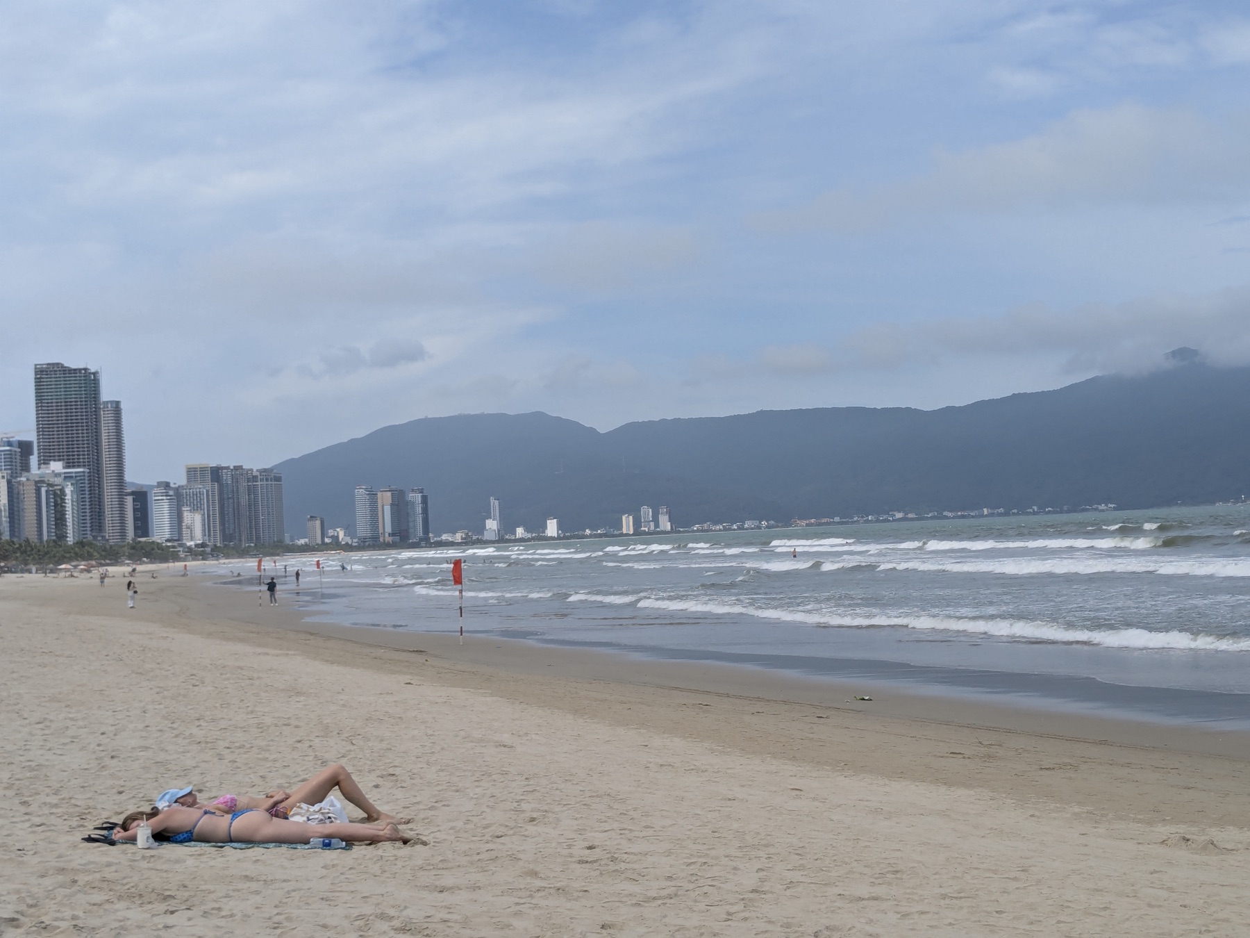 Wide beach in Da Nang with mountains beyond the shoreline
