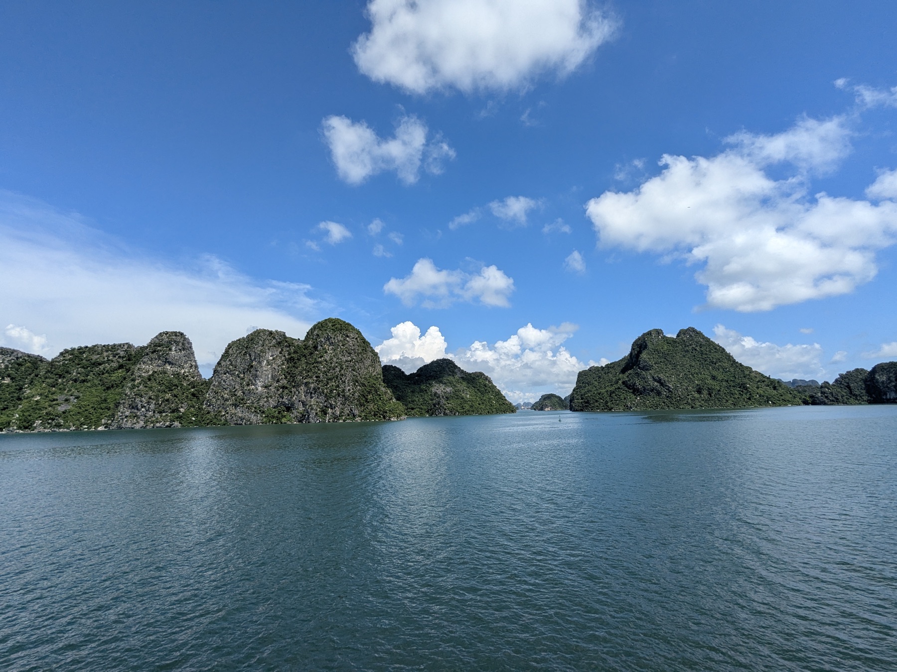 Limestone islands rising from blue water in Ha Long Bay