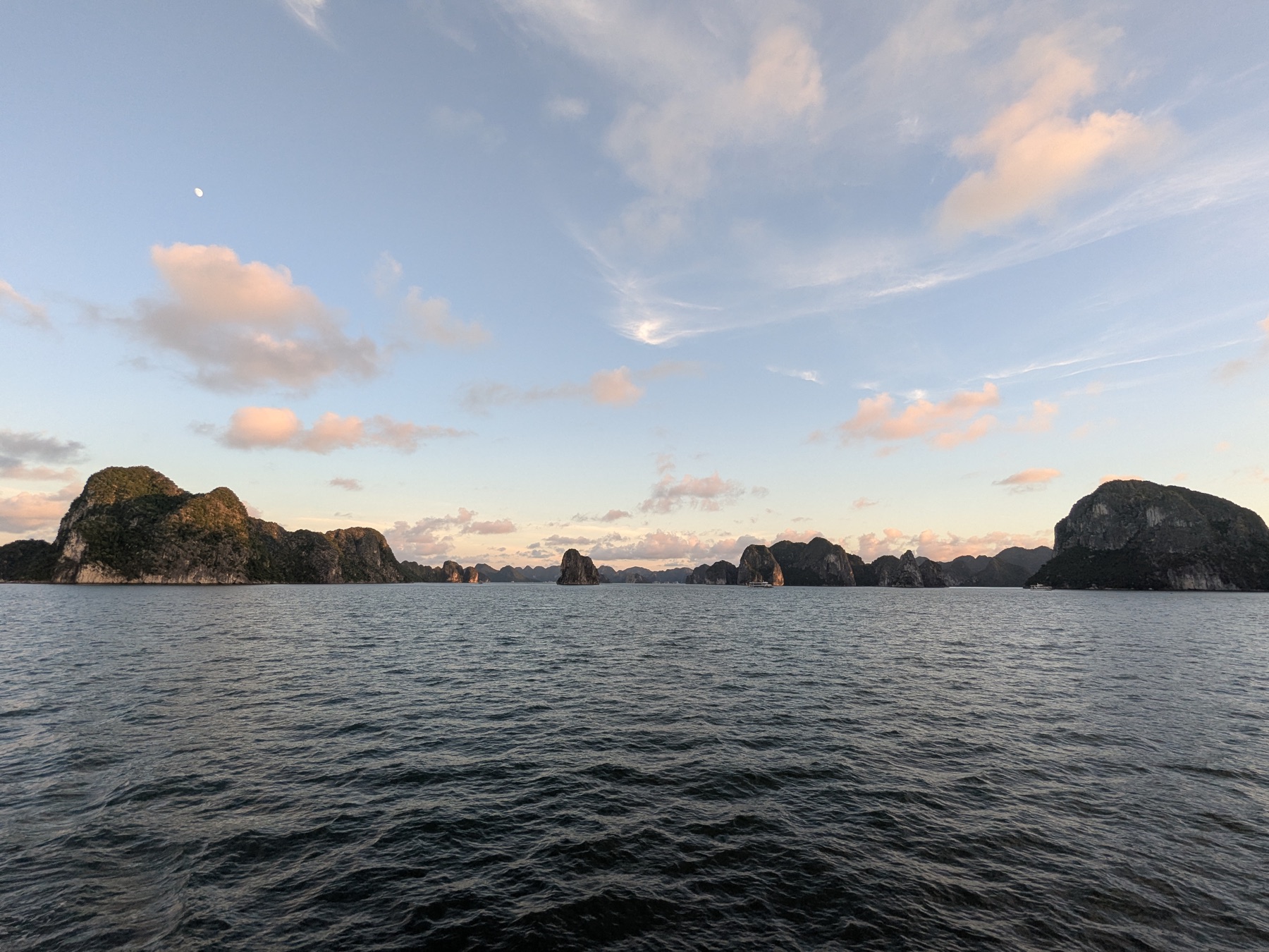 Pastel sunset above the limestone islands of Ha Long Bay